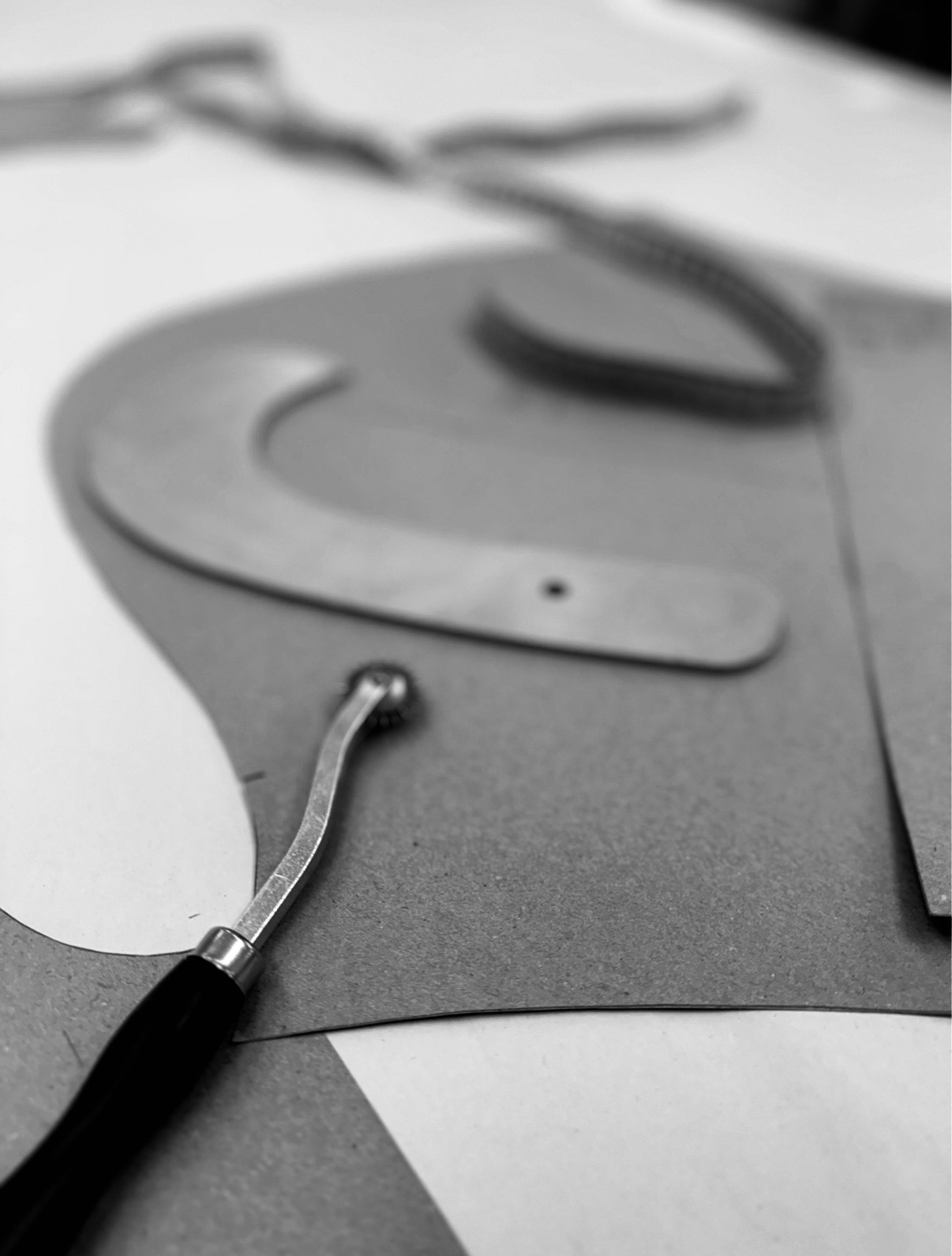 Racks of finished patterns and garments in studio