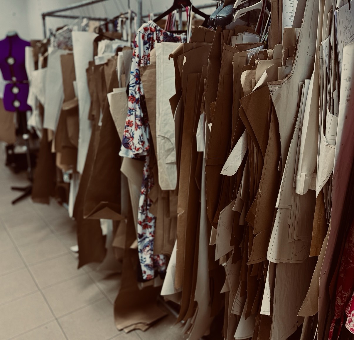Racks of patterns and garments inside the atelier